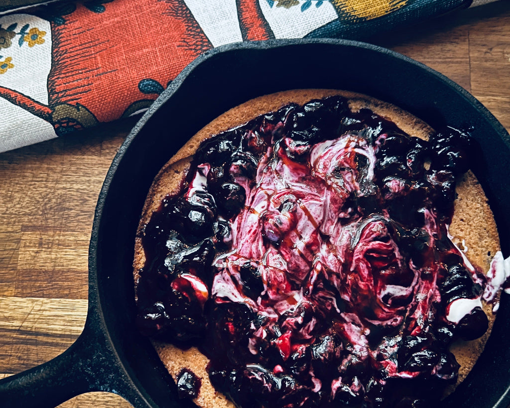 high protein gluten free dutch baby oven pancake almond flour greek yogurt refined sugar free breakfast dish with date syrup and blueberries